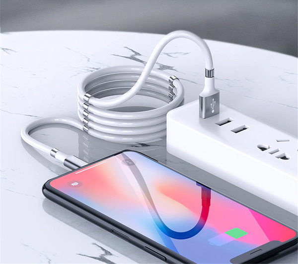 FlashWire coiled usb a to lightning charger connecting to phone on countertop